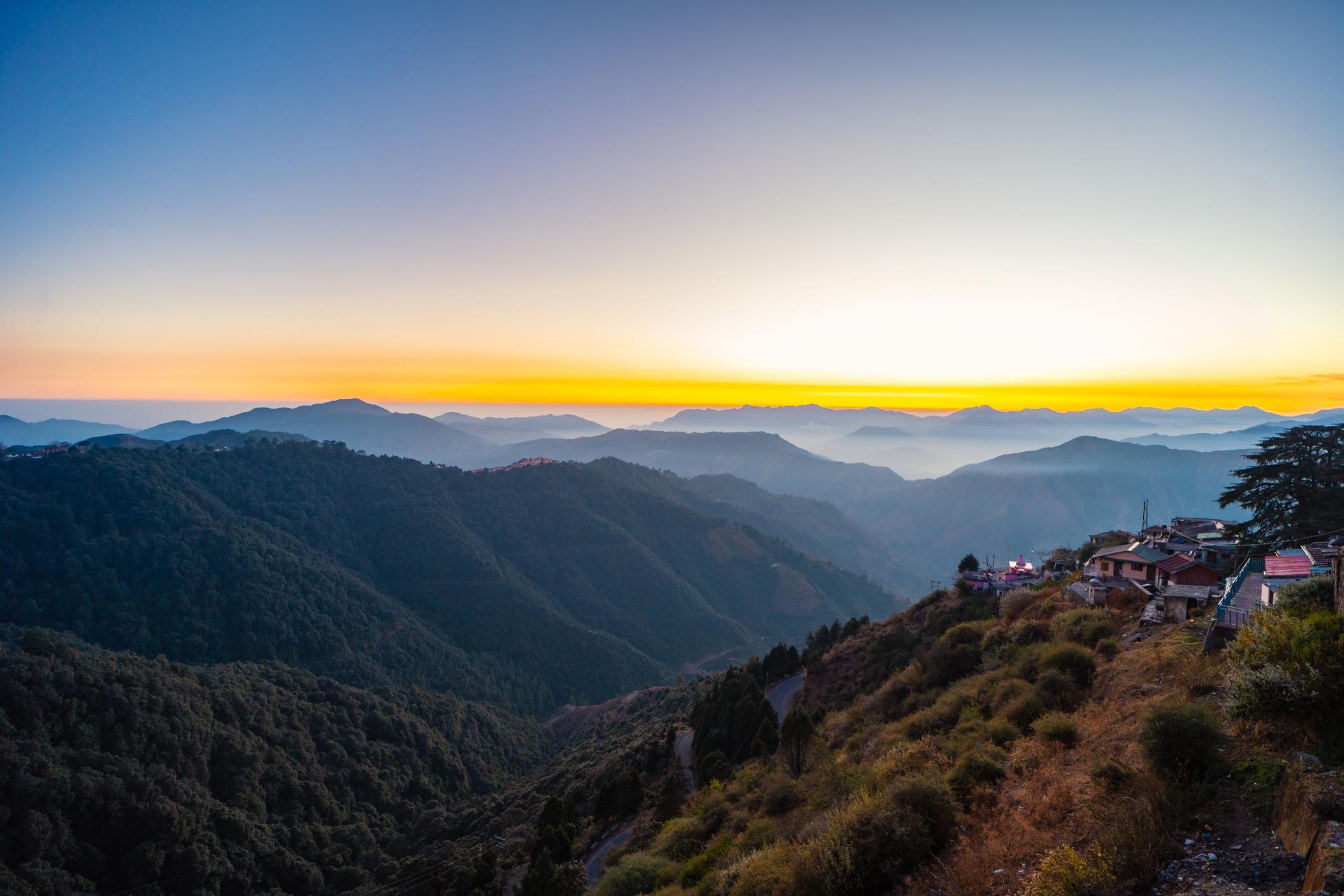 Sunset over layered mountain ridges in Chakrata